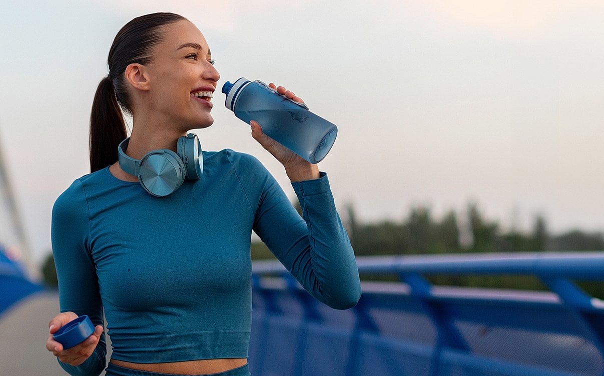 Woman in yellow bikini relaxing at beach.